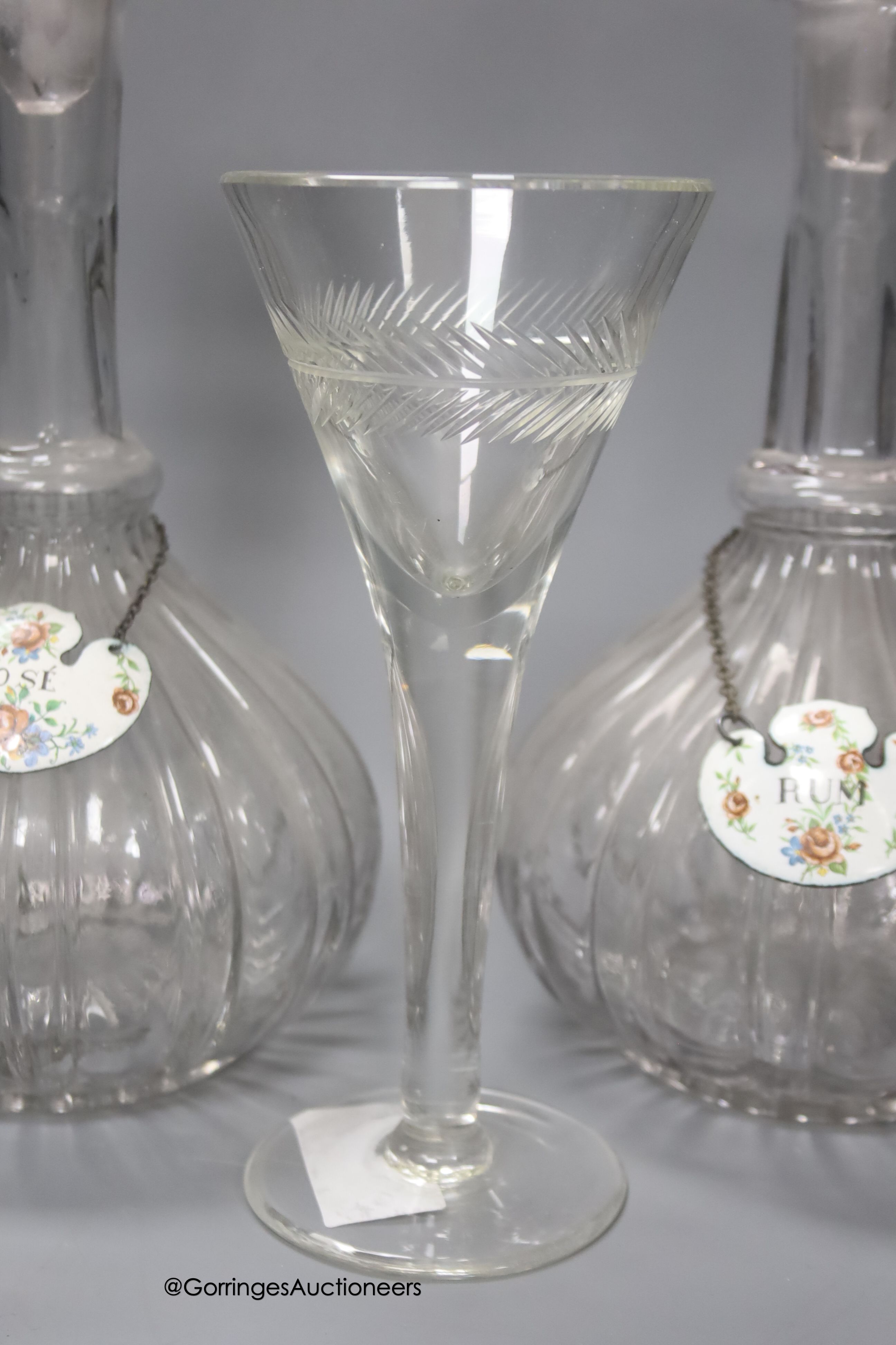 A pair of glass decanters with enamelled labels, 32cm, a pair of cut glass vinegar bottles and a Georgian style wine glass